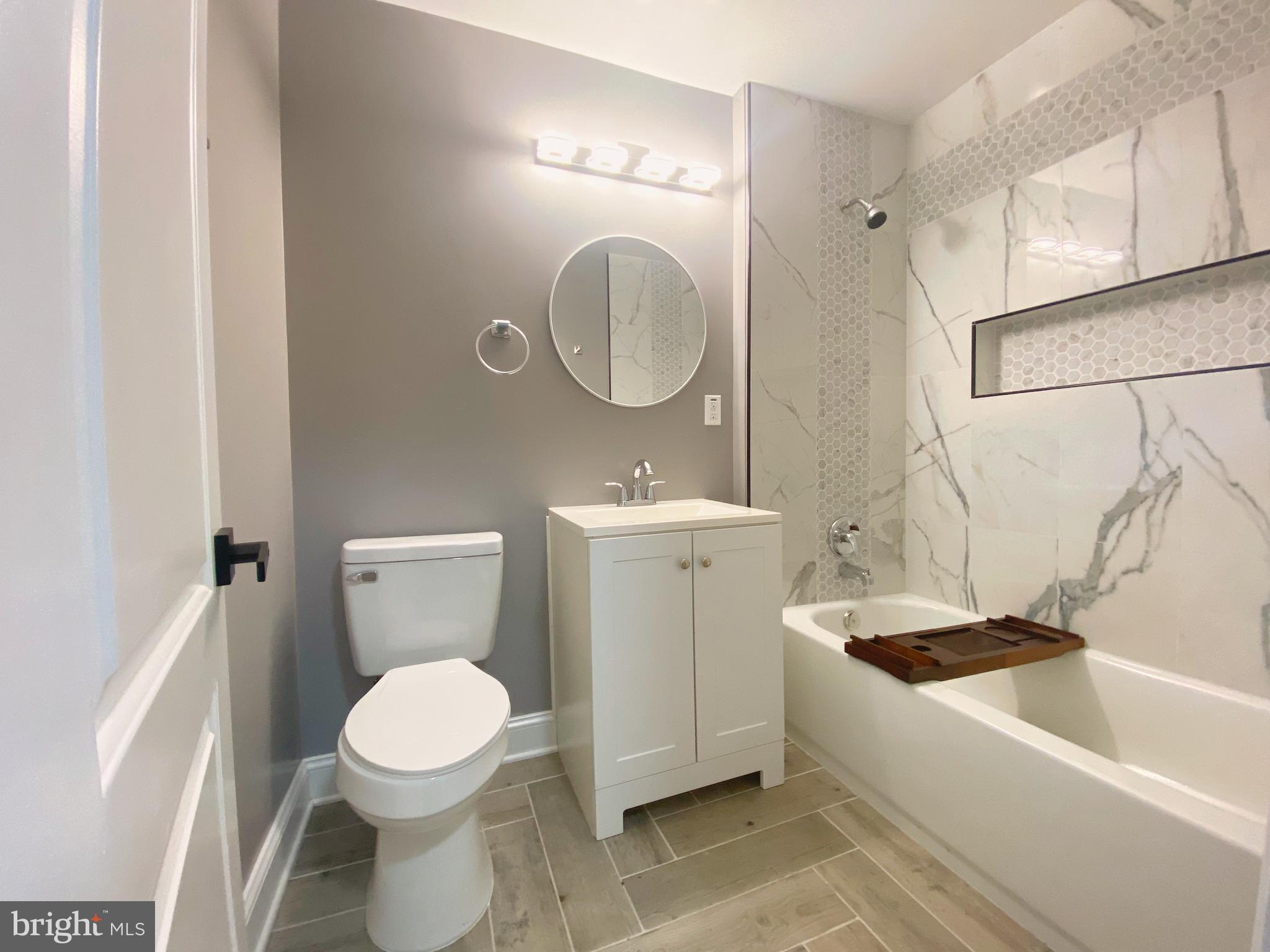 1604 Cliftview Avenue Baltimore, MD 21213 - Photo 17 of 36 a bathroom with a sink toilet and a mirror