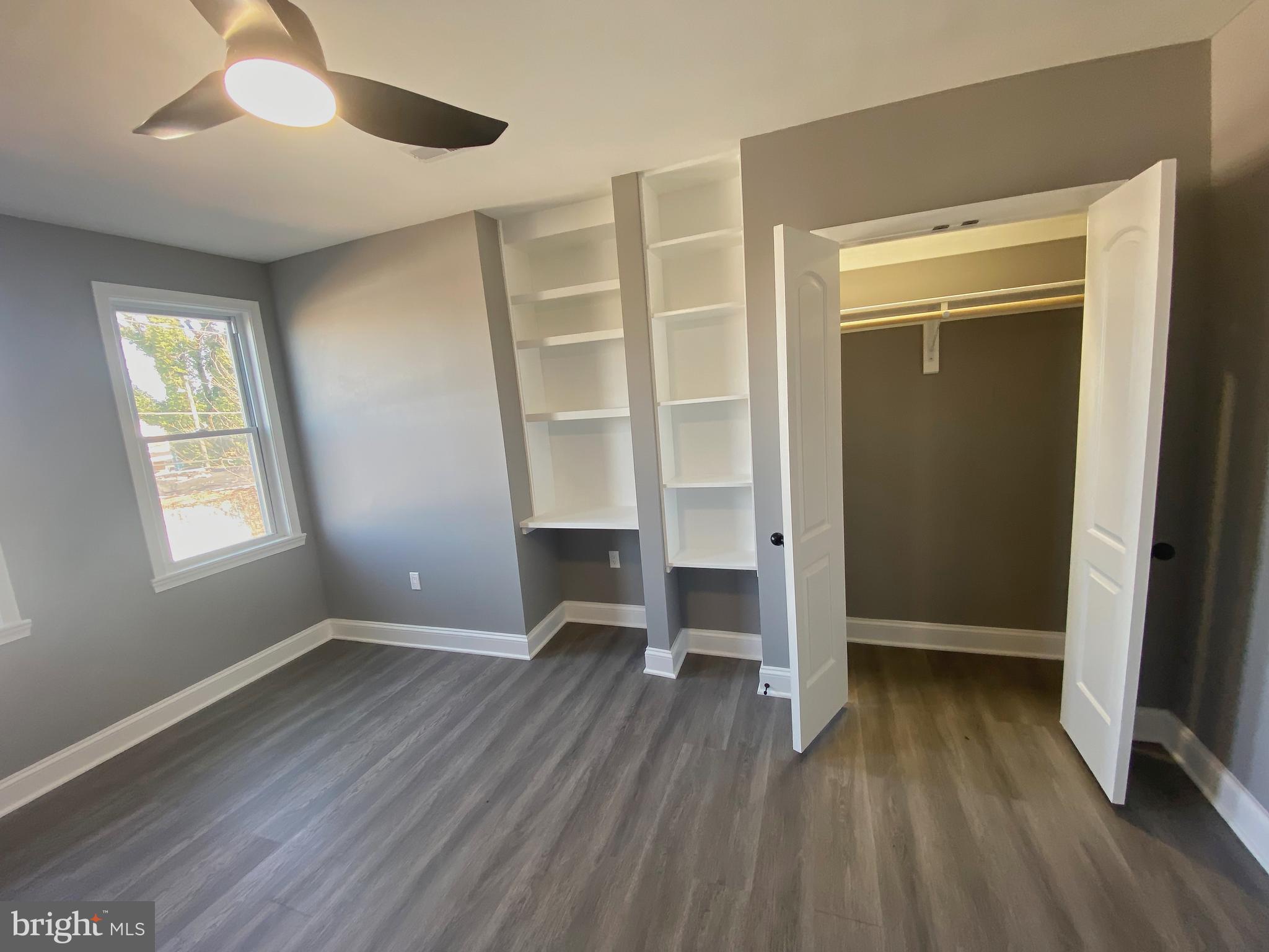 1604 Cliftview Avenue Baltimore, MD 21213 - Photo 22 of 36 wooden floor in an empty room with a window