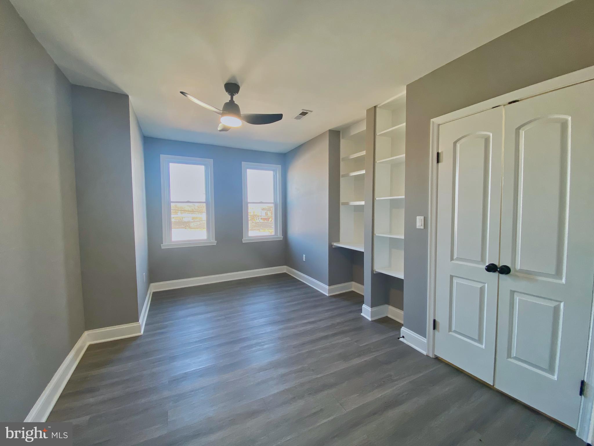 1604 Cliftview Avenue Baltimore, MD 21213 - Photo 25 of 36 wooden floor in an empty room with a window