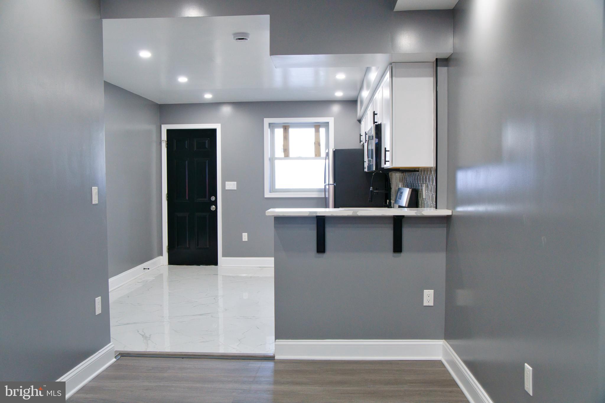 1604 Cliftview Avenue Baltimore, MD 21213 - Photo 2 of 36 a kitchen with kitchen island sink and faucet