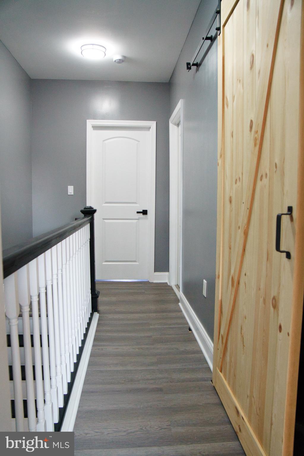1604 Cliftview Avenue Baltimore, MD 21213 - Photo 30 of 36 a view of a hallway with wooden floor and staircase