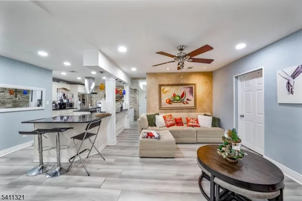 a living room with furniture and kitchen view