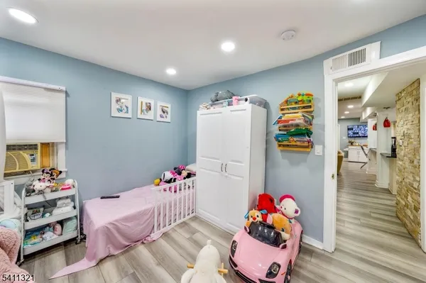 a bedroom with furniture and a book shelf