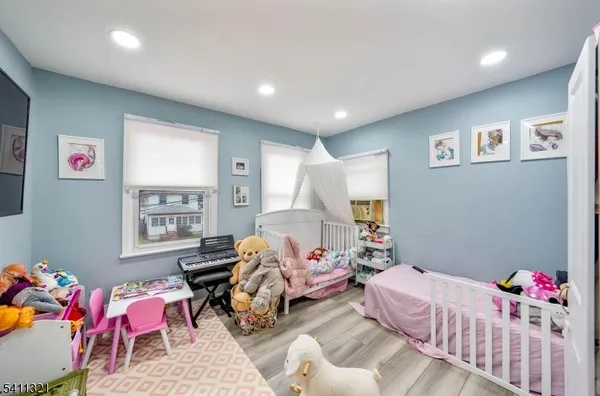 a bedroom with furniture and a window