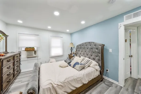 a bedroom with a large bed and a flat tv screen