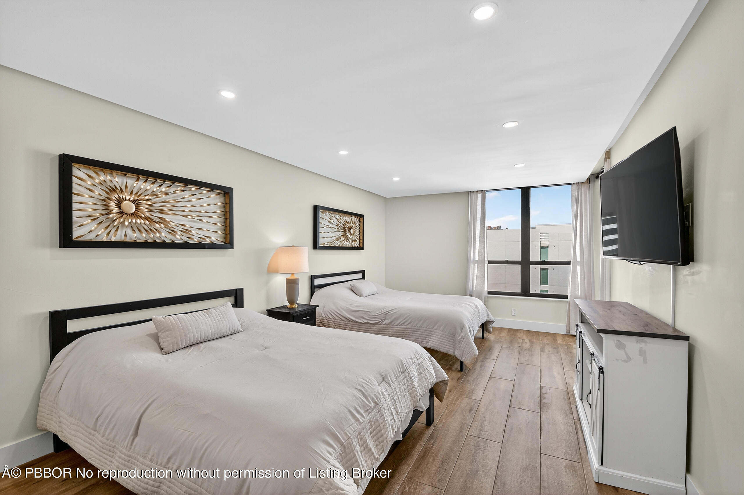 3610 South Ocean Boulevard, Unit 608 Palm Beach, FL 33480 - Photo 18 of 38 a bedroom with two large bed and a flat screen tv