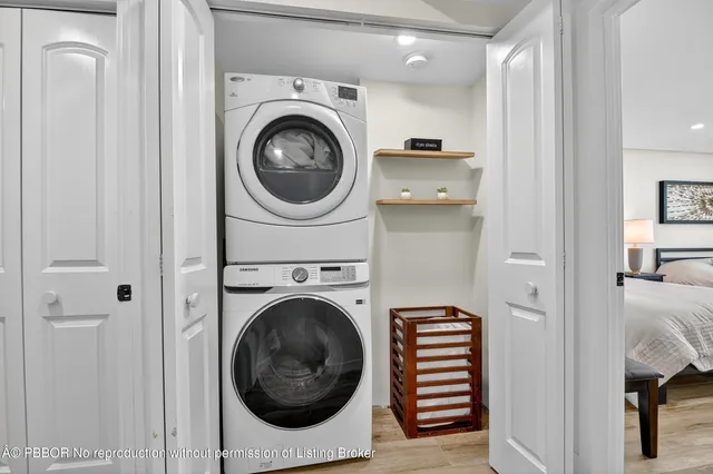 a view of a hallway with washer and dryer