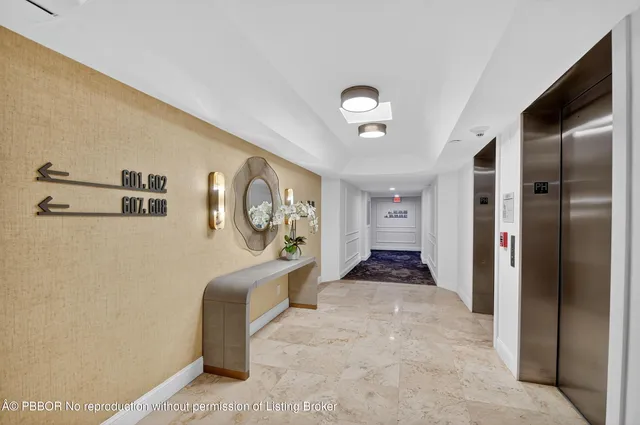 a hallway with sliding door and furniture