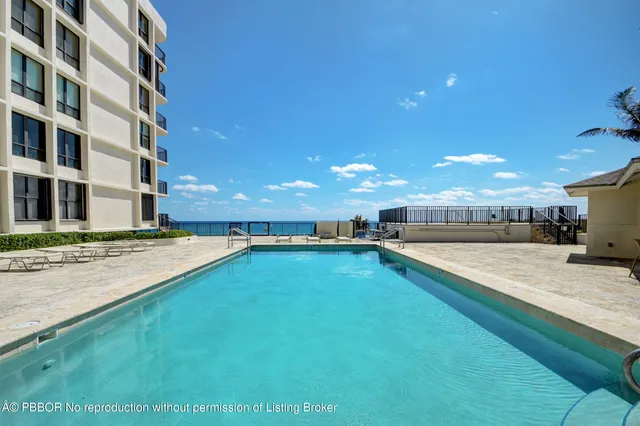 a view of a living room and swimming pool