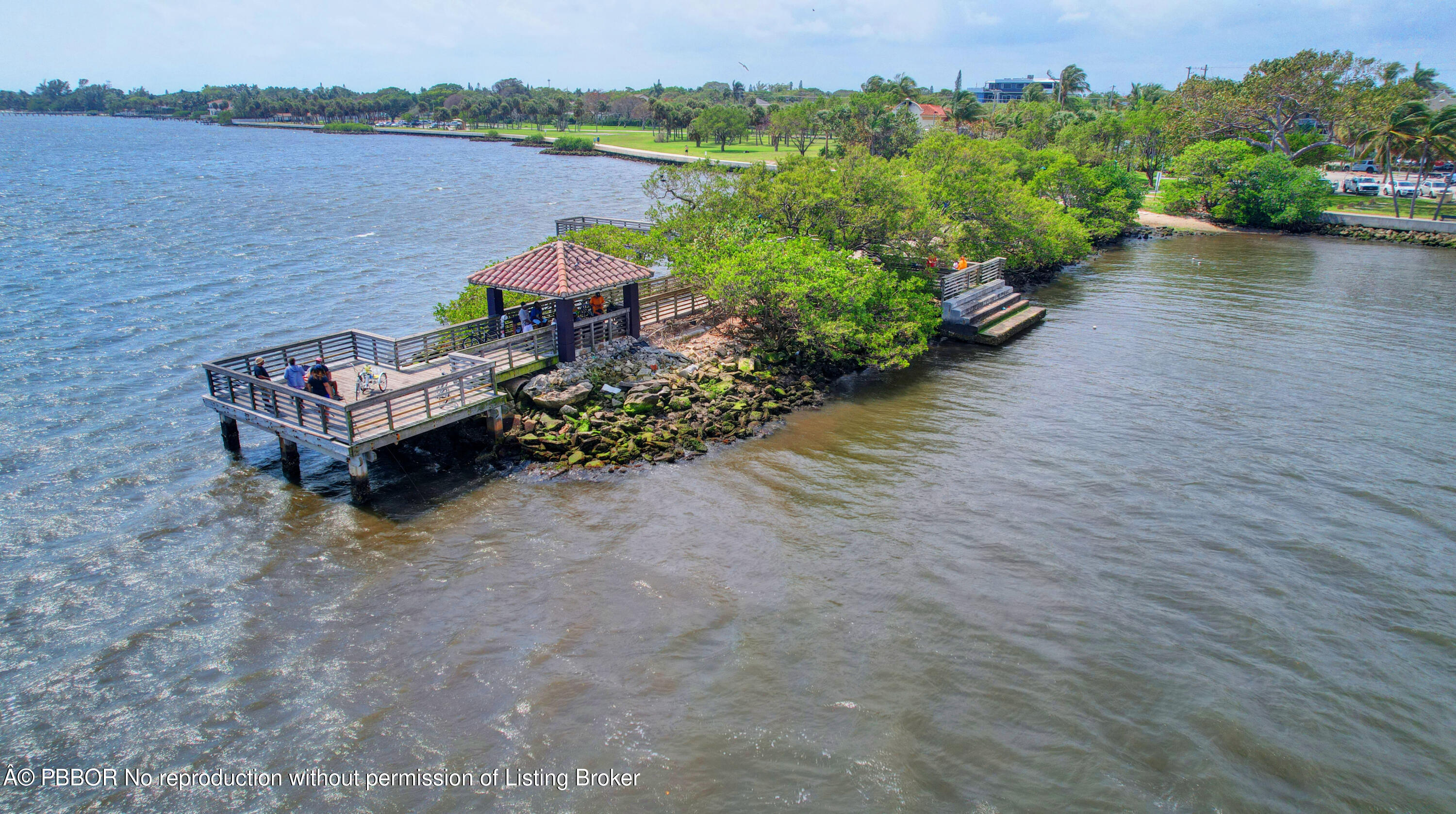 3610 South Ocean Boulevard, Unit 608 Palm Beach, FL 33480 - Photo 37 of 38 a view of a lake with a bench next to a lake