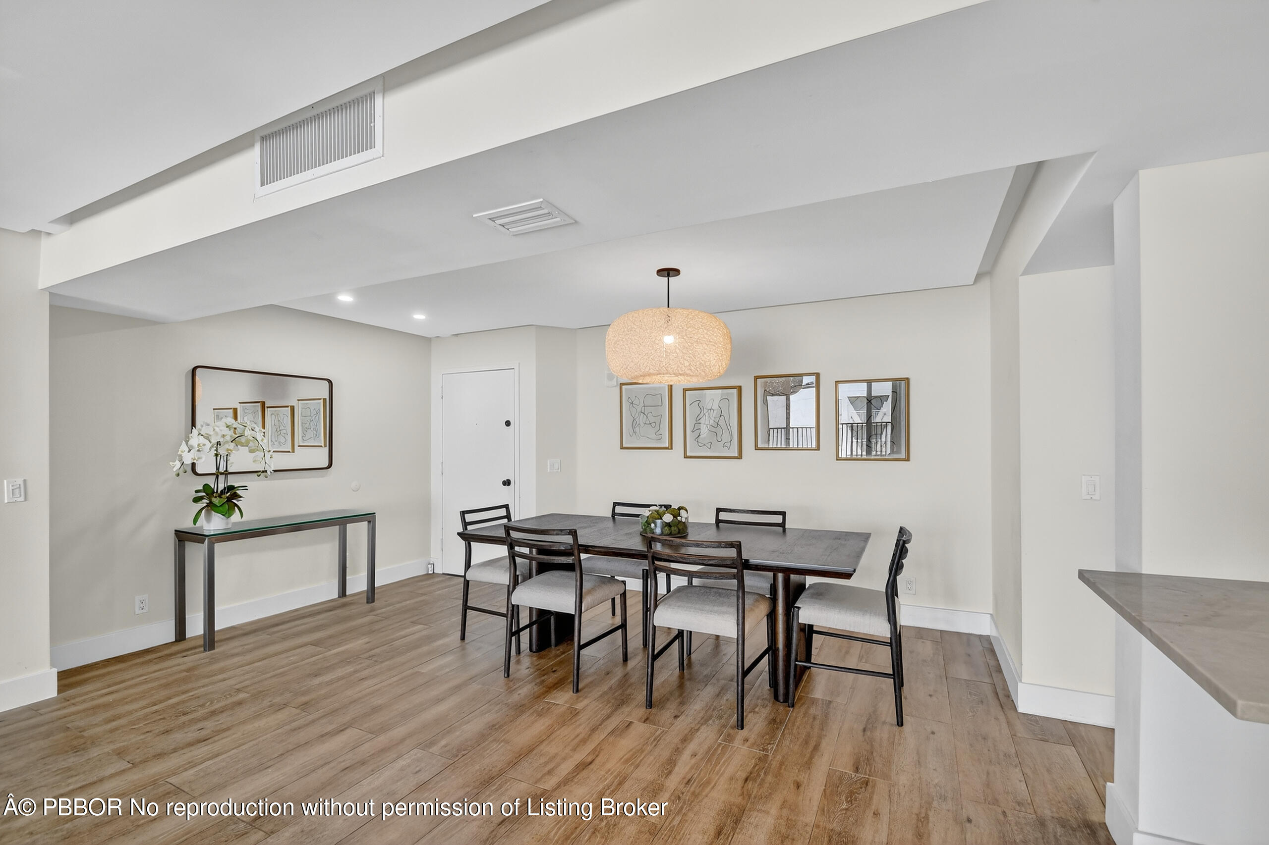 3610 South Ocean Boulevard, Unit 608 Palm Beach, FL 33480 - Photo 4 of 38 a view of a dining room with furniture and wooden floor
