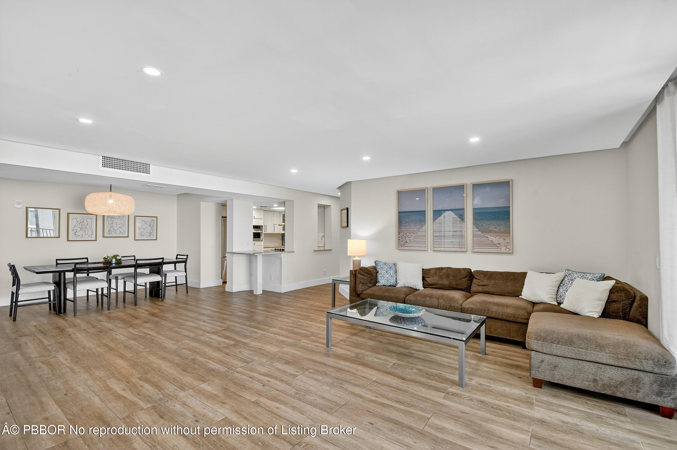 3610 South Ocean Boulevard, Unit 608 Palm Beach, FL 33480 - Photo 8 of 38 a living room with furniture and a dining table with wooden floor