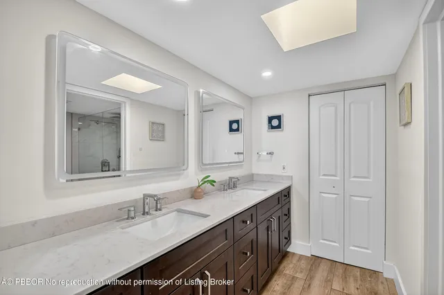 a spacious bathroom with a double vanity sink and a mirror
