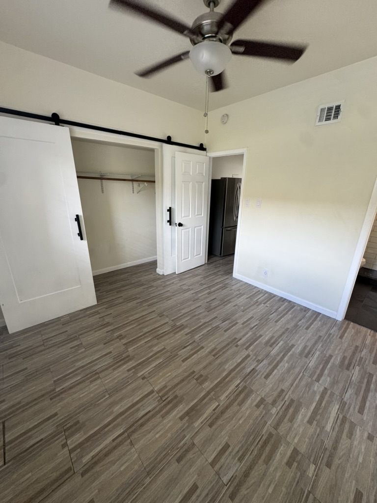 3000 Guadalupe Street, Unit 214 Austin, TX 78705 - Photo 3 of 7 a view of empty room with wooden floor
