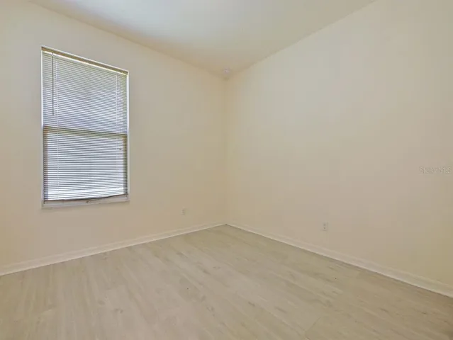 an aerial view of a house with a garden and lake view