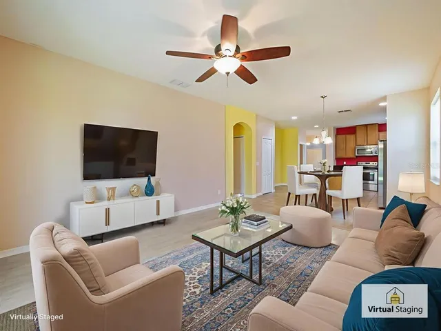 a living room with furniture a rug and a flat screen tv
