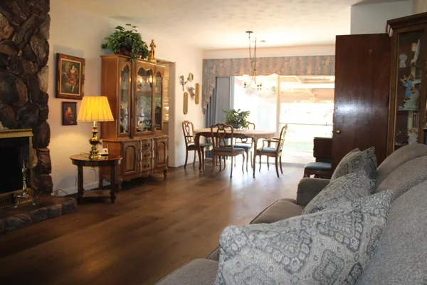 a living room with furniture window and wooden floor