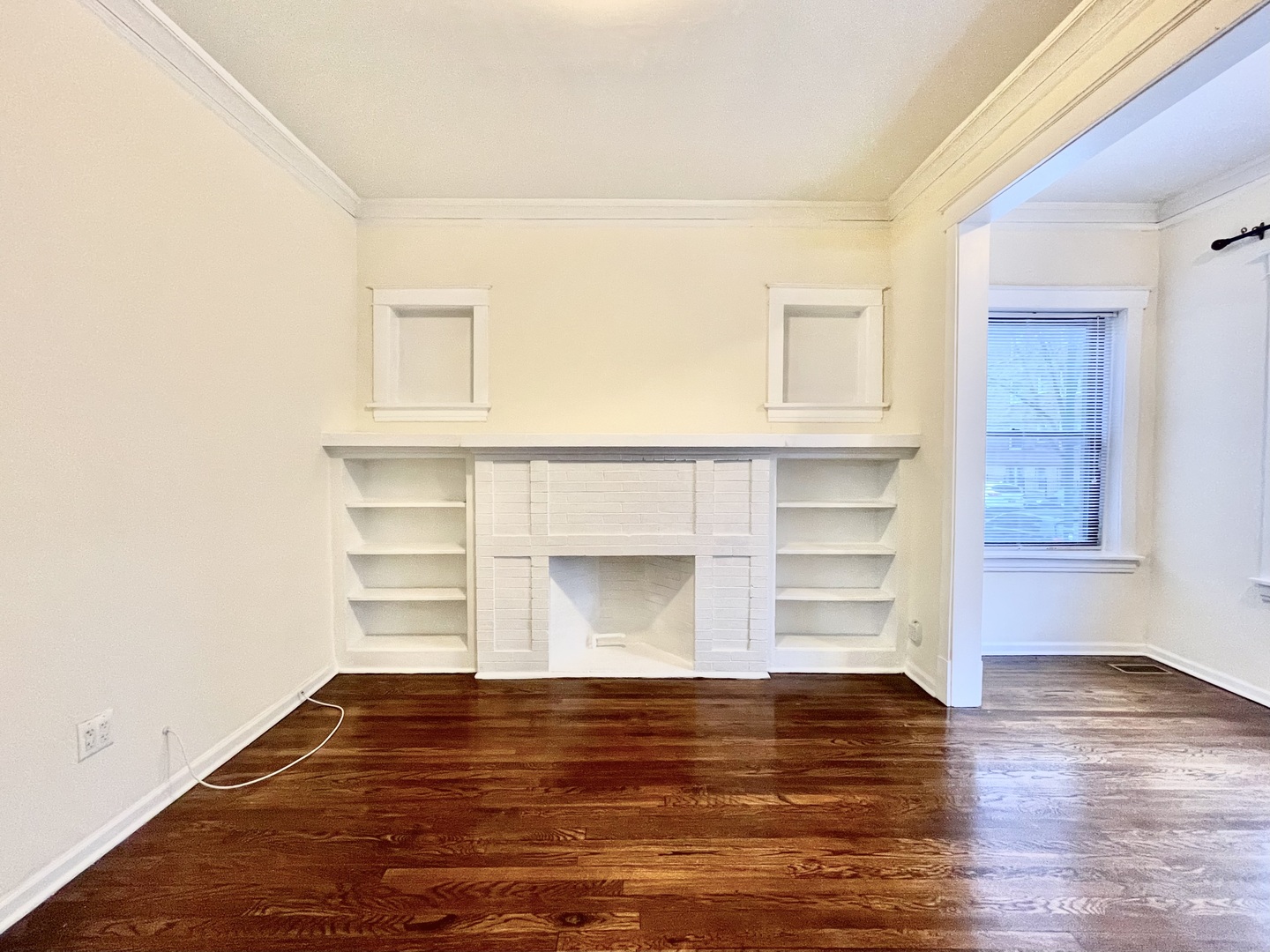 4349 North Spaulding Avenue, Unit 1 Chicago, IL 60618 - Photo 11 of 18 a view of empty room with wooden floor and fireplace