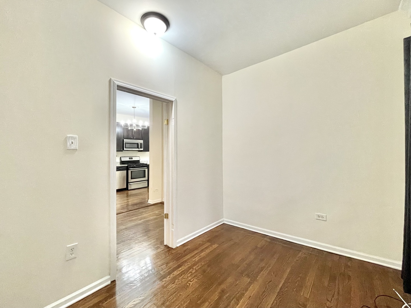 4349 North Spaulding Avenue, Unit 1 Chicago, IL 60618 - Photo 16 of 18 an empty room with wooden floor and a window