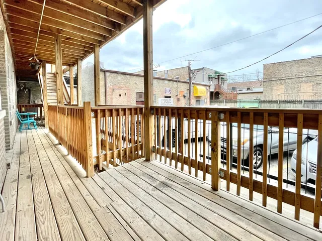 a view of a balcony with wooden floor