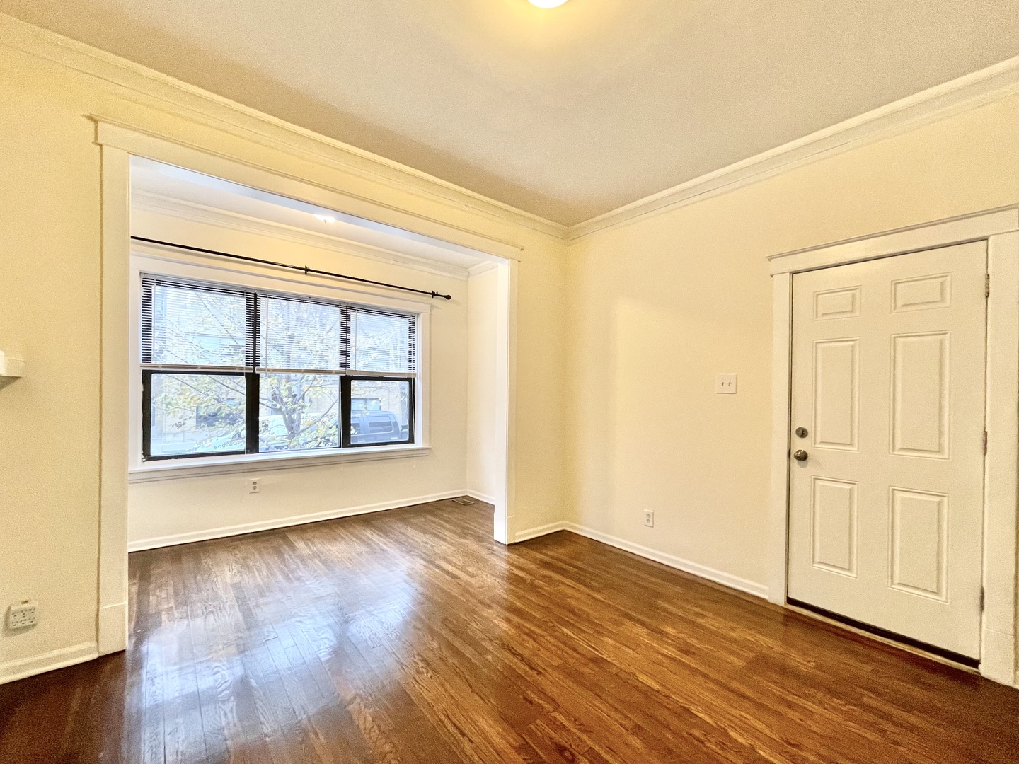 4349 North Spaulding Avenue, Unit 1 Chicago, IL 60618 - Photo 3 of 18 an empty room with wooden floor and windows