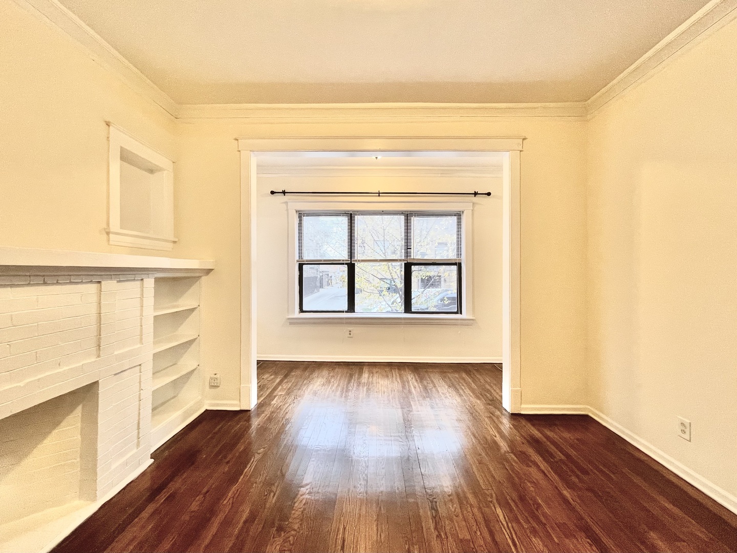 4349 North Spaulding Avenue, Unit 1 Chicago, IL 60618 - Photo 10 of 18 a view of an empty room with wooden floor and a window