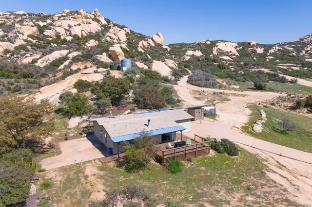a view of a backyard of a house with a yard