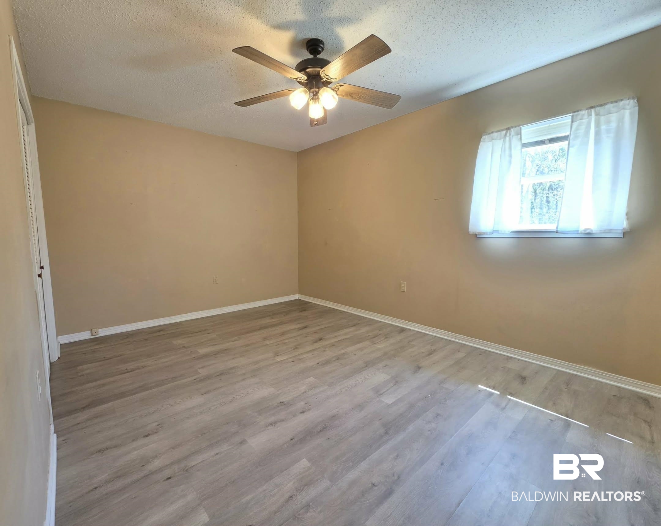 11 Coal Fire Road Jackson, AL 36545 - Photo 21 of 23 Unfurnished room featuring light wood finished floors, a textured ceiling, and ceiling fan