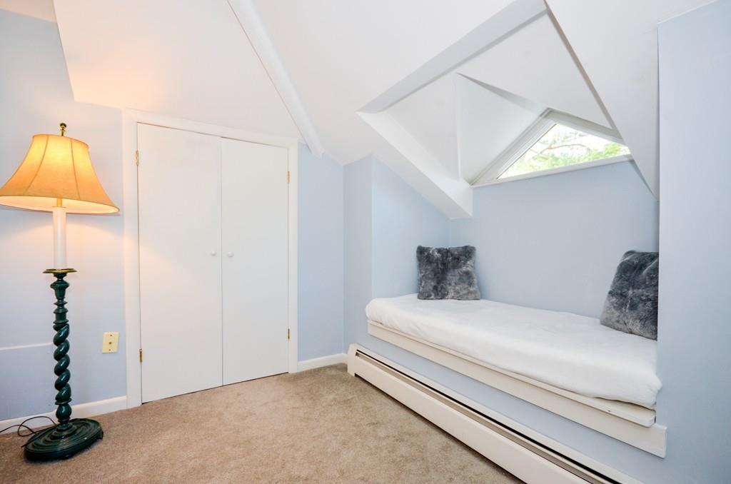 18 Zora Road Marion, MA 02738 - Photo 26 of 37 a bedroom with a bed and a potted plant