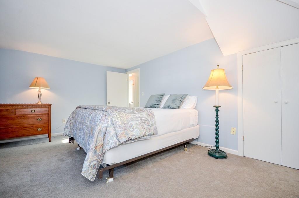 18 Zora Road Marion, MA 02738 - Photo 27 of 37 a bedroom with a bed and a lamp