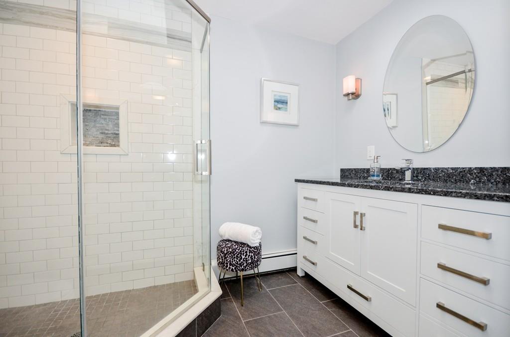 18 Zora Road Marion, MA 02738 - Photo 32 of 37 a spacious bathroom with a granite countertop sink mirror and a shower