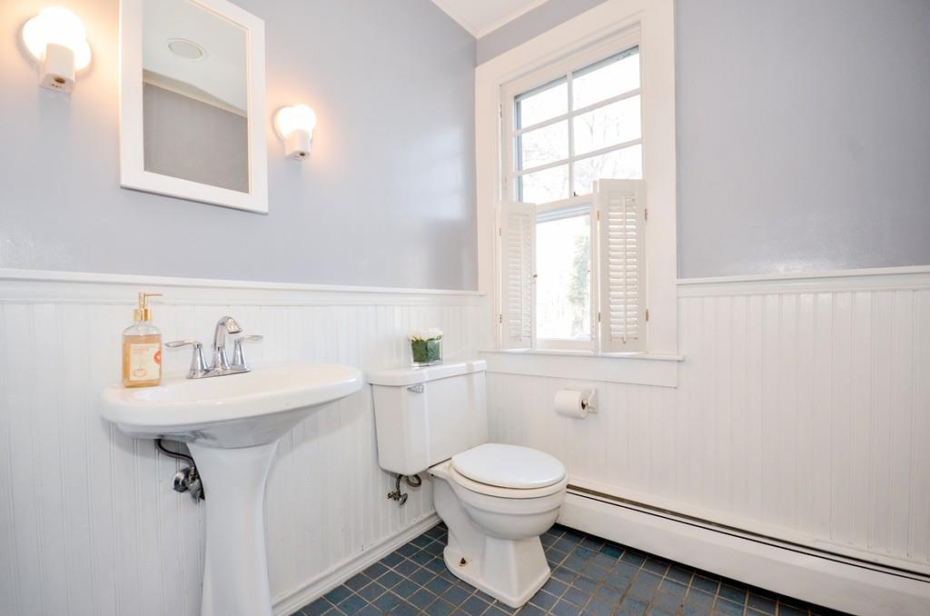 18 Zora Road Marion, MA 02738 - Photo 33 of 37 a bathroom with a toilet a sink a mirror and a window
