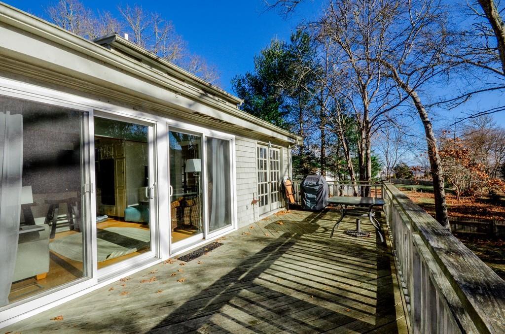 18 Zora Road Marion, MA 02738 - Photo 36 of 37 a view of a balcony with two couches and deck with wooden floor and fence