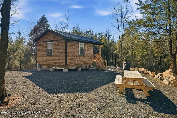 a view of backyard with sitting area