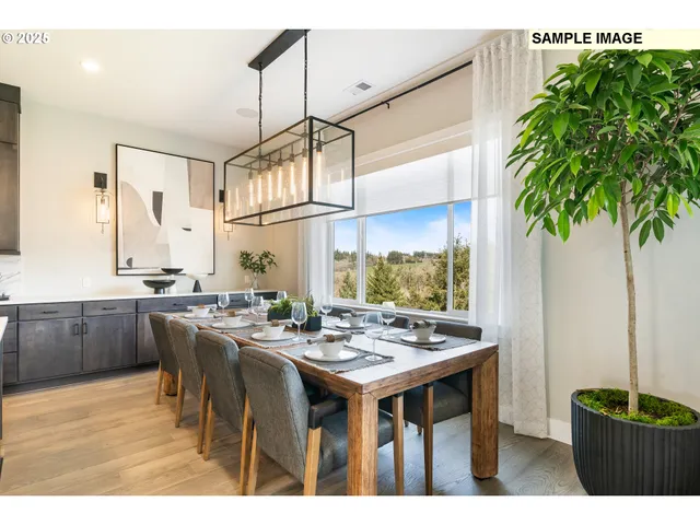 a open kitchen with stainless steel appliances kitchen island granite countertop a table chairs sink and cabinets