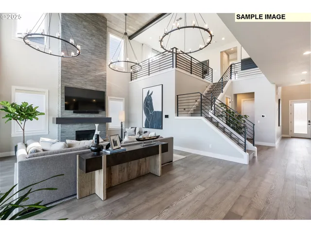 a view of living room kitchen with stainless steel appliances kitchen island a stove a wooden floor and a sink