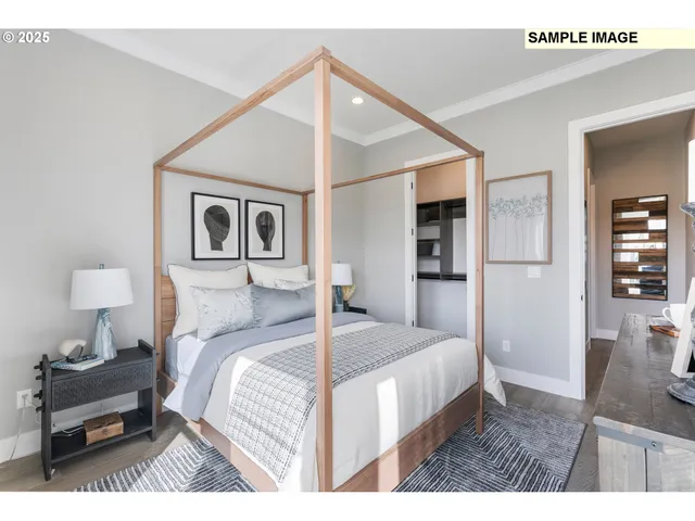 a bedroom with a bed and a painting on the wall