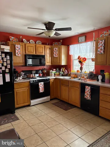 a kitchen with stainless steel appliances granite countertop a stove cabinets and window