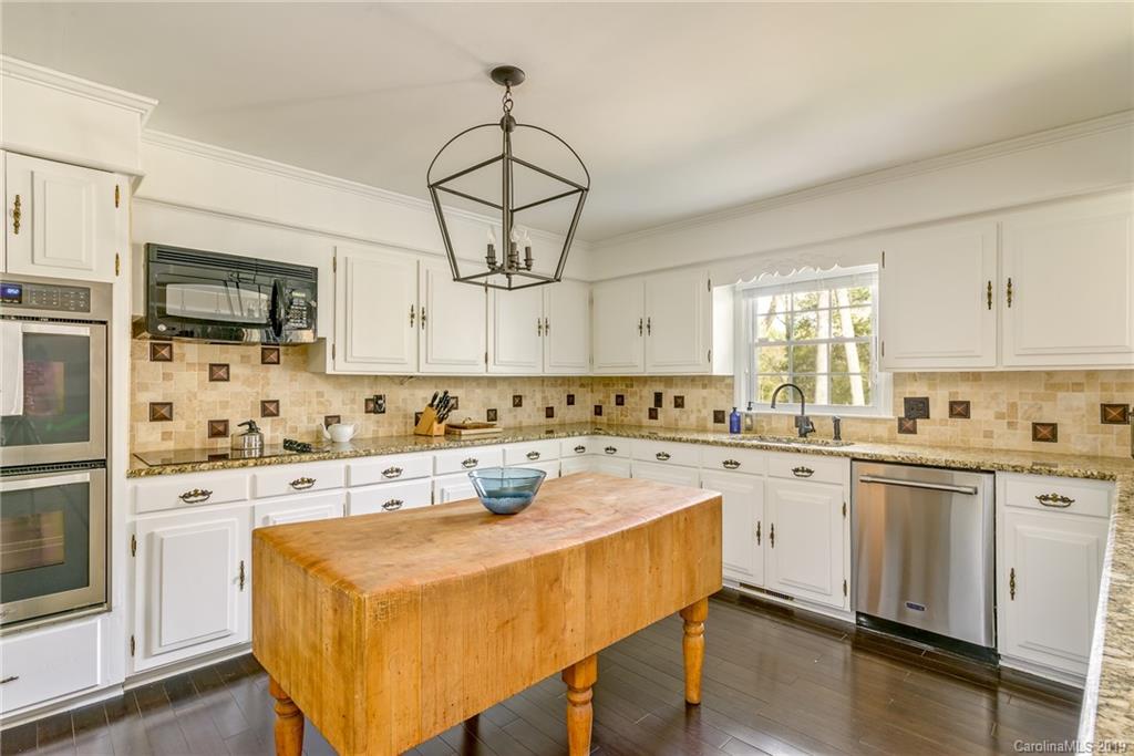 3224 Allenwood Road Charlotte, NC 28270 - Photo 12 of 38 a kitchen with stainless steel appliances a stove a sink and white cabinets