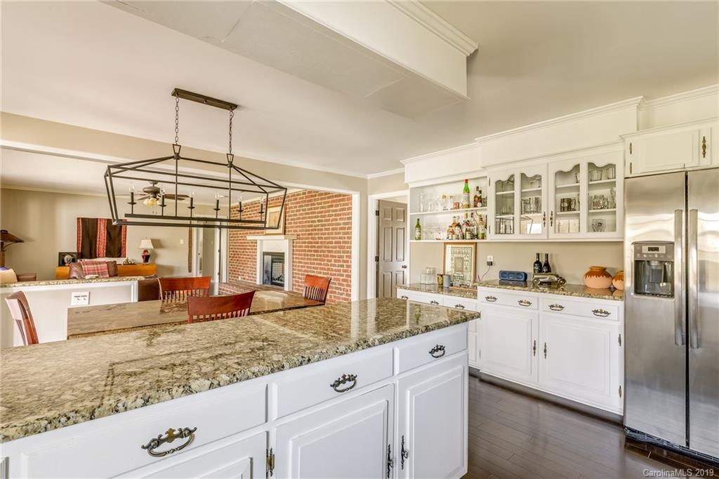 3224 Allenwood Road Charlotte, NC 28270 - Photo 14 of 38 a kitchen with granite countertop a sink a stove and cabinets