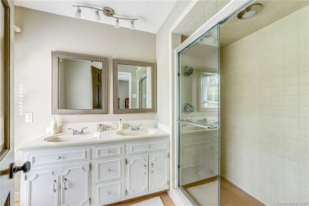3224 Allenwood Road Charlotte, NC 28270 - Photo 22 of 38 a bathroom with a shower sink and mirror