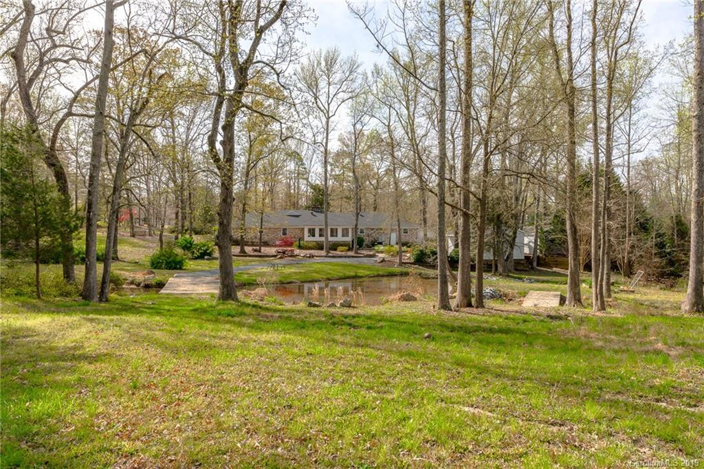 3224 Allenwood Road Charlotte, NC 28270 - Photo 36 of 38 a swimming pool with trees in the background