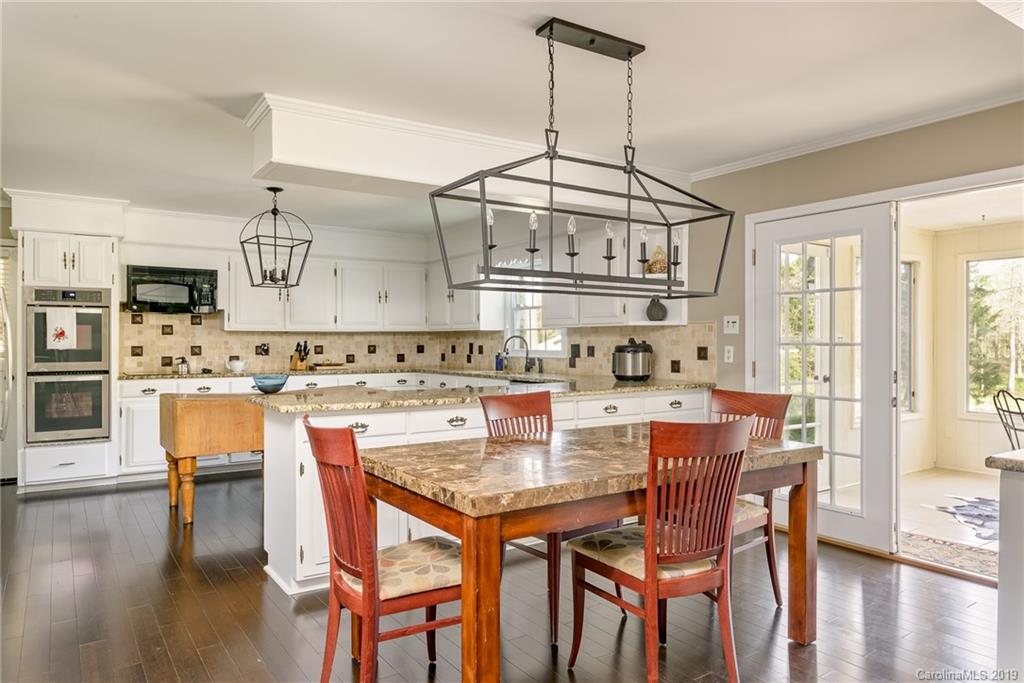 3224 Allenwood Road Charlotte, NC 28270 - Photo 10 of 38 a dining table with chairs and wooden floor
