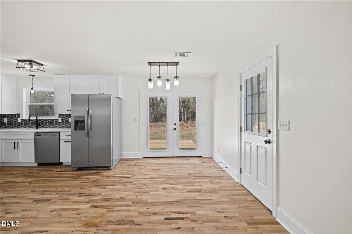 598 Bentonville Road Four Oaks, NC 27524 - Photo 13 of 40 a kitchen with stainless steel appliances a refrigerator and a stove