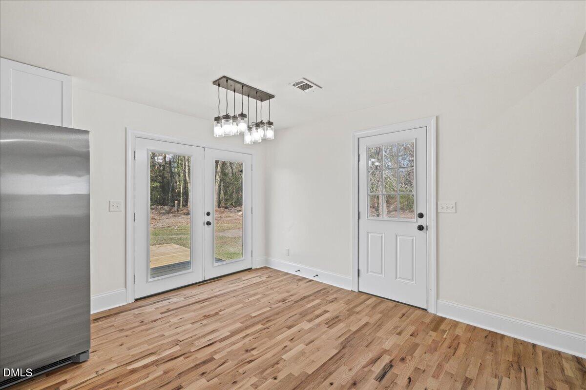 598 Bentonville Road Four Oaks, NC 27524 - Photo 14 of 40 a view of empty room with wooden floor