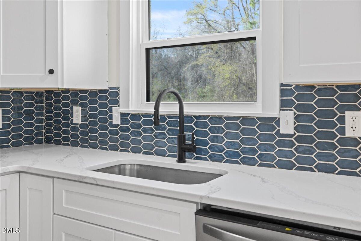 598 Bentonville Road Four Oaks, NC 27524 - Photo 18 of 40 a bathroom with a sink and a mirror