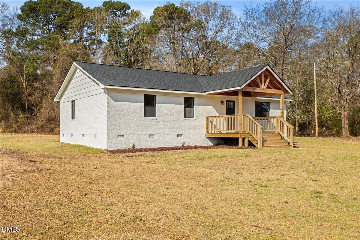 598 Bentonville Road Four Oaks, NC 27524 - Photo 2 of 40 a view of house with backyard and trees in the background