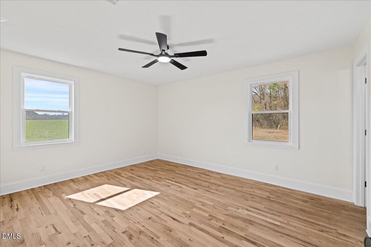 598 Bentonville Road Four Oaks, NC 27524 - Photo 26 of 40 a view of a big room with wooden floor closet and windows