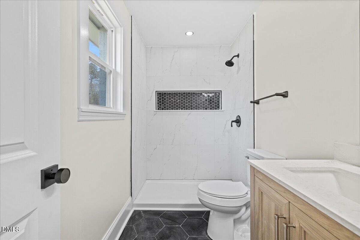 598 Bentonville Road Four Oaks, NC 27524 - Photo 29 of 40 a bathroom with a sink a toilet and shower