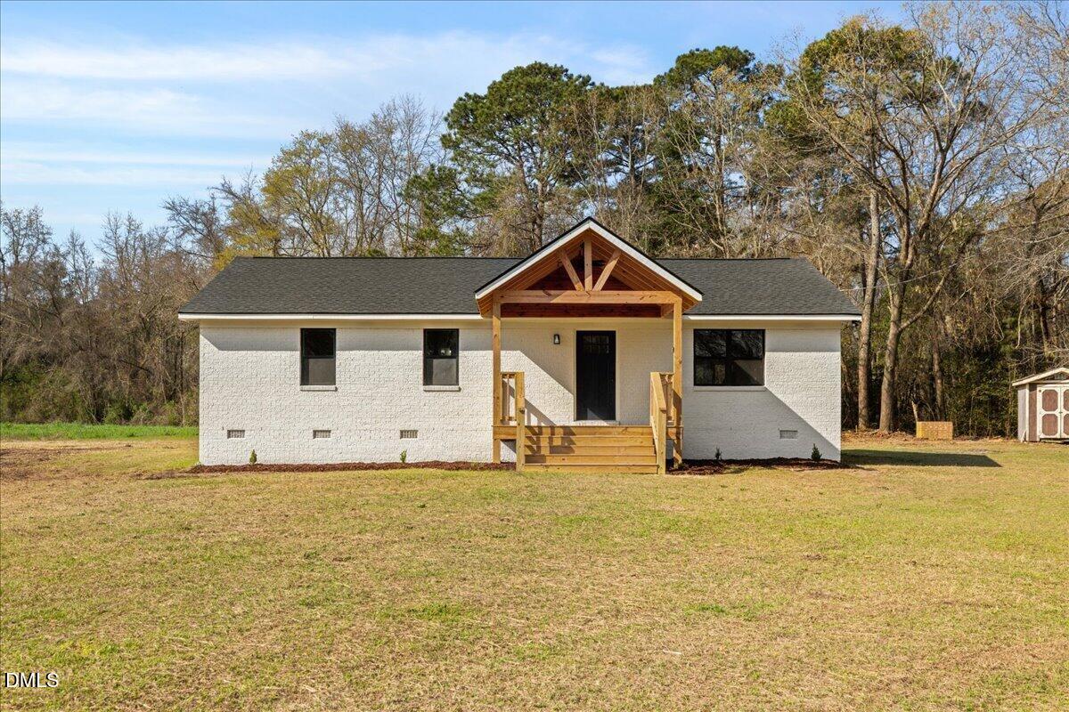 598 Bentonville Road Four Oaks, NC 27524 - Photo 3 of 40 a front view of a house with a yard